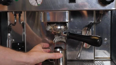 Close-up of coffee pouring from a professional coffee machine into a cup. Stock Footage 344038757