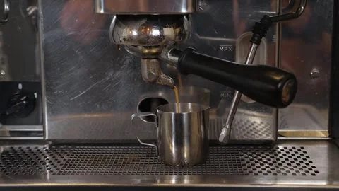 Close-up of coffee pouring from a professional coffee machine into a cup. Stock Footage 345132889