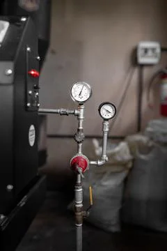 Close up of a coffee roaster machine pressure meter Stock Photos