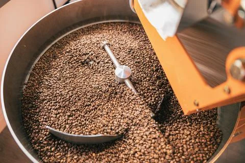 Close up of coffee roasting machine with coffee beans in small coffee Stock Photos