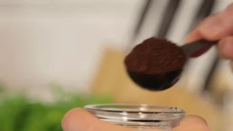 Close up coffee scoops from a jar, defocussed kitchen background. Stock Footage 79836125
