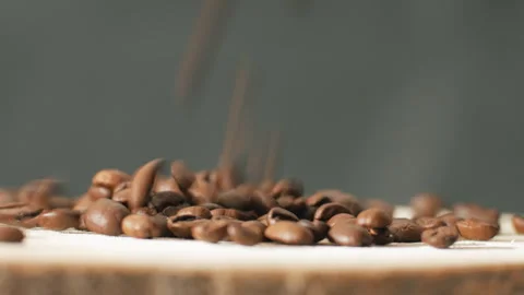 Close up of coffee seeds. Fragrant roasted coffee beans are poured into a heap Stock Footage 263339470