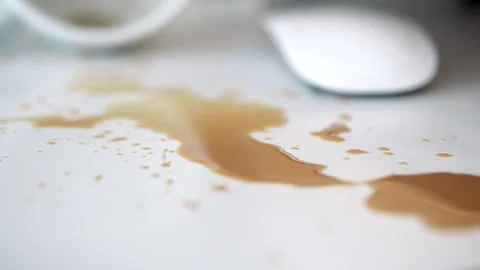 Close up of coffee spilled on a white office desk with a computer mouse nearb 스톡 동영상 332886485