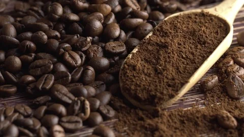 Close-up of coffee spoon with roasted coffee beans on wooden background Stock Footage 84770348
