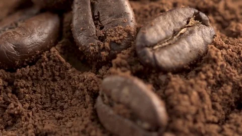 Close-up of coffee spoon with roasted coffee beans on wooden background Stock Footage 84770637