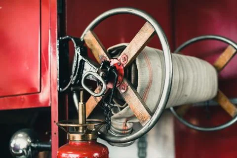Close-up of coiled fire hose of old fire truck. Stock Photos