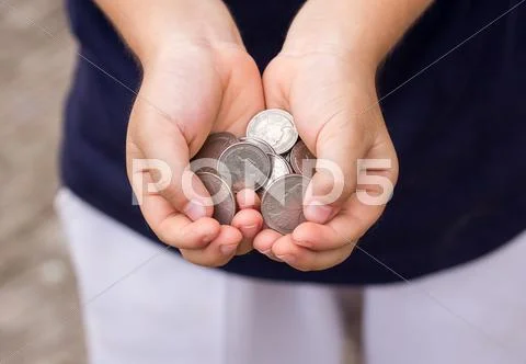 Close up coin in children hand Stock Photos
