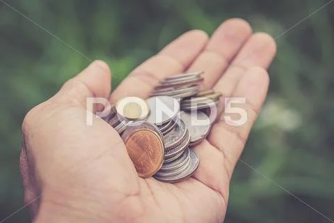Close up coin in hand Stock Photos