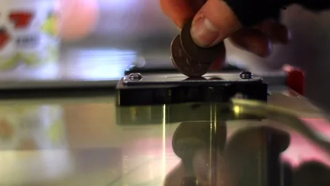 Close Up of Coins Being Inserted Into Arcade Slot Machine Vídeo Stock 94473407