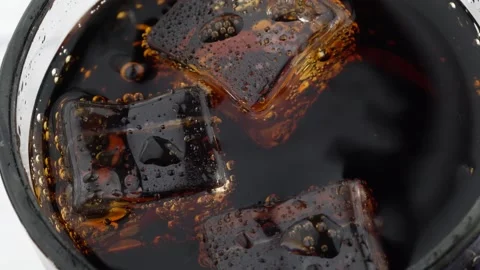 Close-up of cola bubbles and Ice cubes in a glass. Stock Footage 136103284