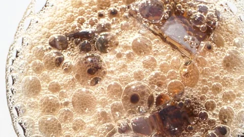 Close-up of cola with ice cubes and bubbles, top view of carbonated drink, HD Vídeo Stock 153953567
