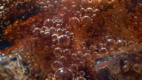 Close-up of cola with ice cubes and bubbles, top view of carbonated drink, HD Stock Footage 155669816