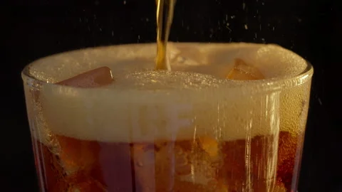 Close up cola pouring into glass with Ice and bubble. Stock Footage 237494384
