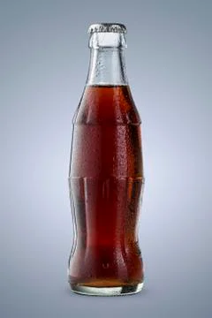 Close up of cold cola bottle isolated on blue background Stock Photos