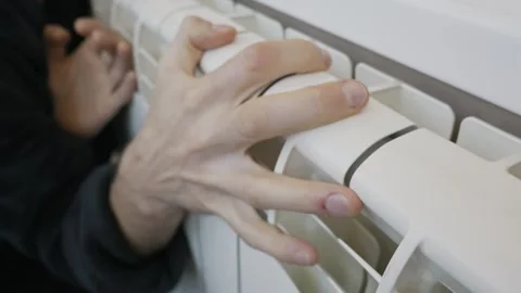 Close Up Of Cold Hands Touching Home Heating Radiator Stock Footage 328480538