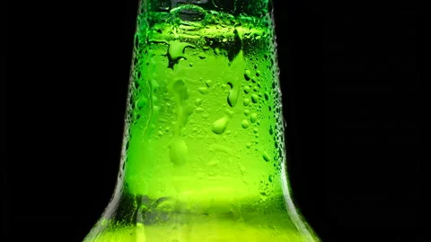 Close up cold neck of a beer bottle with water drops. Cold light and refreshing Stock Footage 156171305