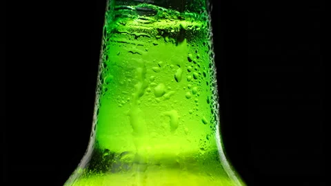 Close up cold neck of a beer bottle with water drops. Stock Footage 164356306