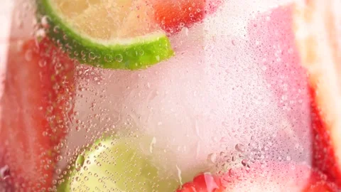 Close up of cold refreshing strawberry and lime lemonade with ice cubes. St.. Stock Footage 276893357