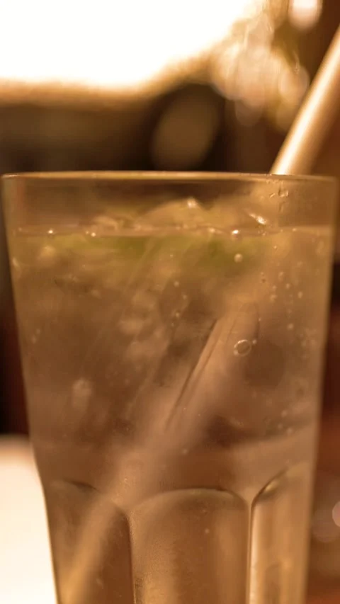 Close Up of Cold Soda Drink with Ice and Straw in Bar Stock Footage 327107605