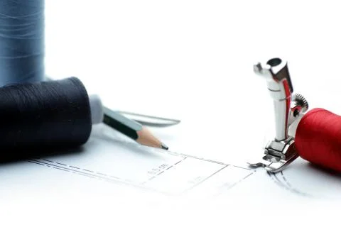 Close-up of collage of thread spool, sewing foot, pencil and scissors on sewi Stock Photos