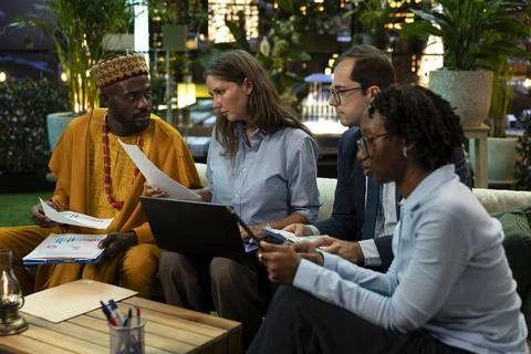 Close up of colleagues in rooftop lounge reading paperwork Stock Photos