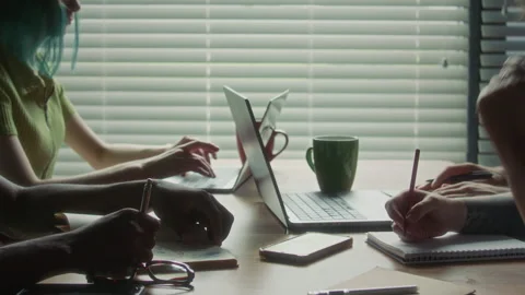 Close Up of Colleagues Typing on Laptop and Writing Notes during Office Meeting Stock Footage 340492766