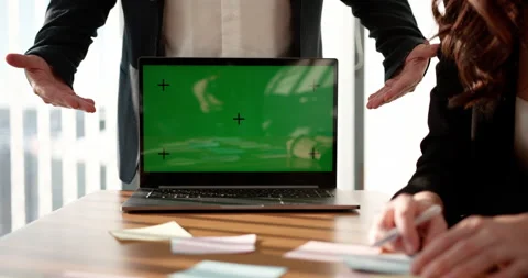 Close up of colleagues using green screen with tracking dot on laptop to work on Stock Footage 233749696