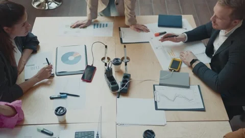 Close up of colleagues working together on project during meeting in modern Stock Footage 244633988