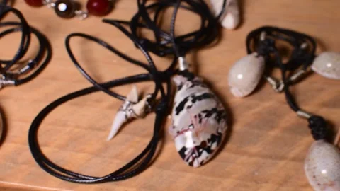 Close-up collection of handmade seashell jewelry crafted from natural marine Stock Footage 337941763