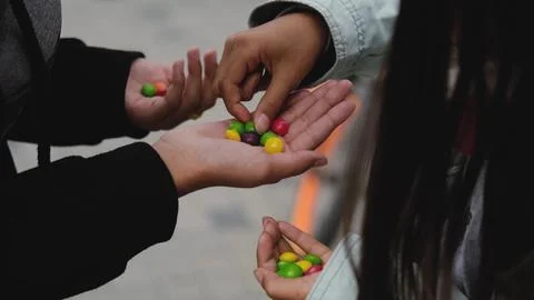 Close-up of colored candy or chewing gum. Children hold a bunch of colorful Fotos Stock