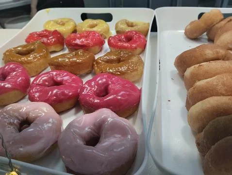 Close-up of colored glazed donuts. White and pink glazed sweet donuts Stock Photos