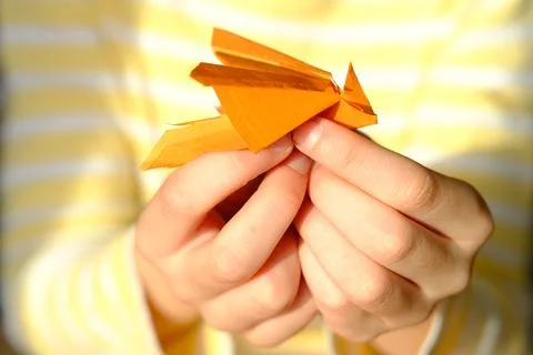 Close-up of colored paper, material for applications, children's hands fold d Stock Photos