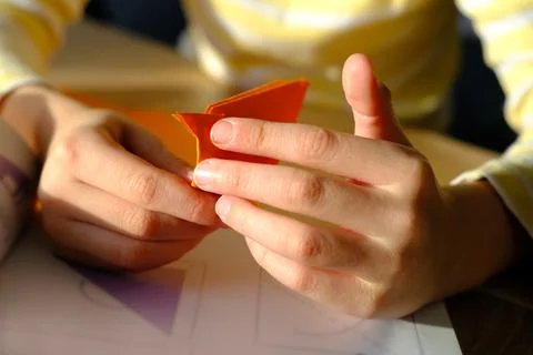 Close-up of colored paper, material for applications, children's hands fold d Stock Photos