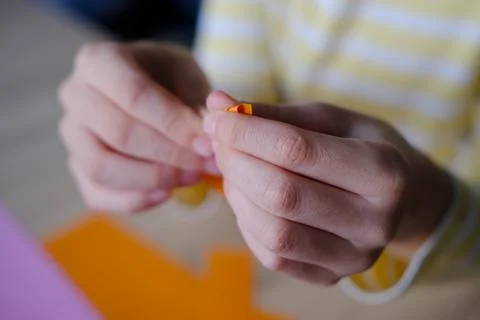 Close-up of colored paper, material for applications, children's hands fold d 写真素材