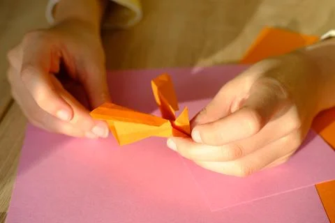 Close-up of colored paper, material for applications, children's hands fold d 写真素材