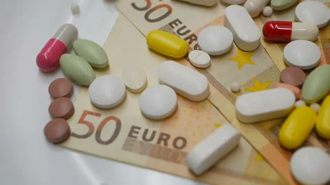 Close up, colored pills rotating on 50s euro banknotes 動画素材 86178311