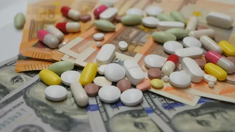 Close up, colored pills rotating on dollars euro banknotes on white backgrounds Stock Footage 86177958