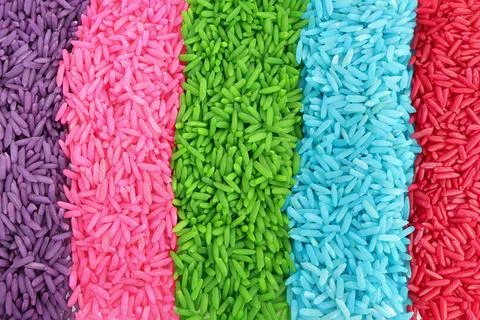 Close up of colored rice on a white background. rainbow color rice Stock Photos