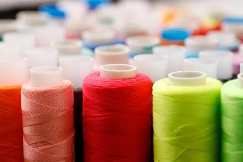 Close up of colored thread coils, thread spools background Stock Photos