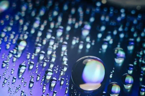 Close up colored water drops on a cd dvd disk background. 스톡 사진