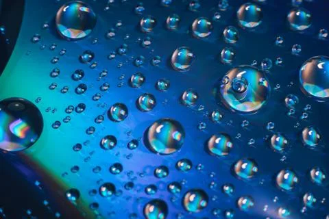 Close up colored water drops on a cd dvd disk background. Foto stock
