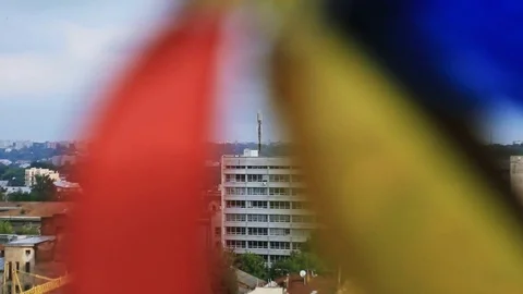 Close-up of colored weather vane in shape of flower. Amazing city view. Old town Stock Footage 98561444