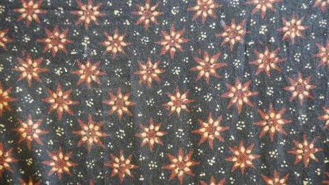 Close up of a colorful batik cloth pattern on black background 스톡 사진