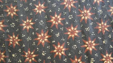 Close up of a colorful batik cloth pattern on black background. 스톡 사진