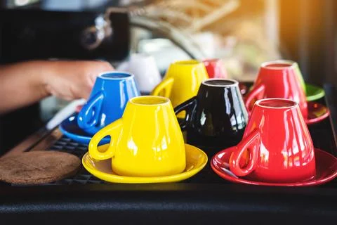 Close up to colorful ceramic upside down coffee cups on coffee machine in caf Stock Photos