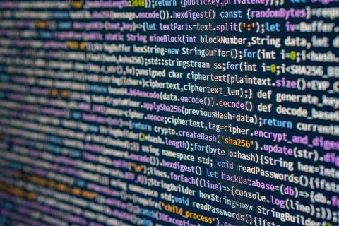 Close-up of colorful digital code on a computer screen, featuring various c.. 写真素材