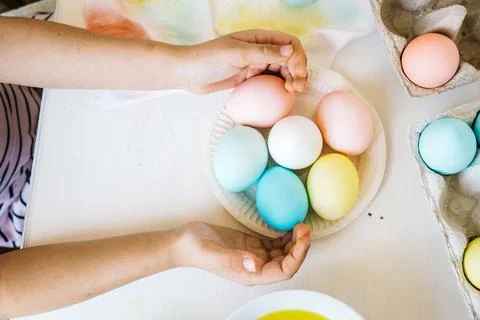 Close up colorful dyed easter eggs in child hands. Preparing to celebrate Eas Stock Photos