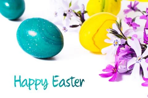 Close-up of colorful easter eggs and phlox flowers on white background with copy Stock Photos