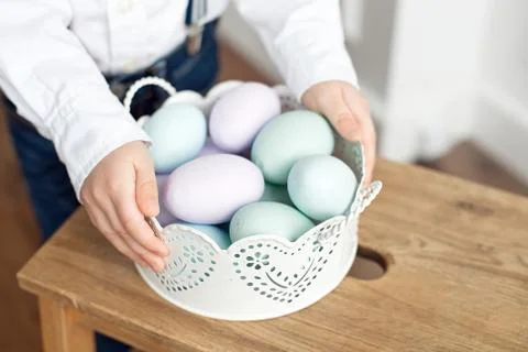 Close up of colorful Easter eggs in a basket. Stock Photos
