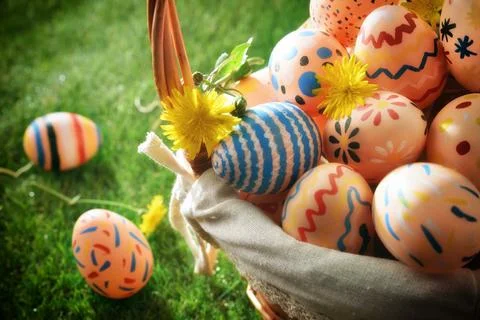 Close Up of Colorful Easter Eggs in Basket Stock Photos